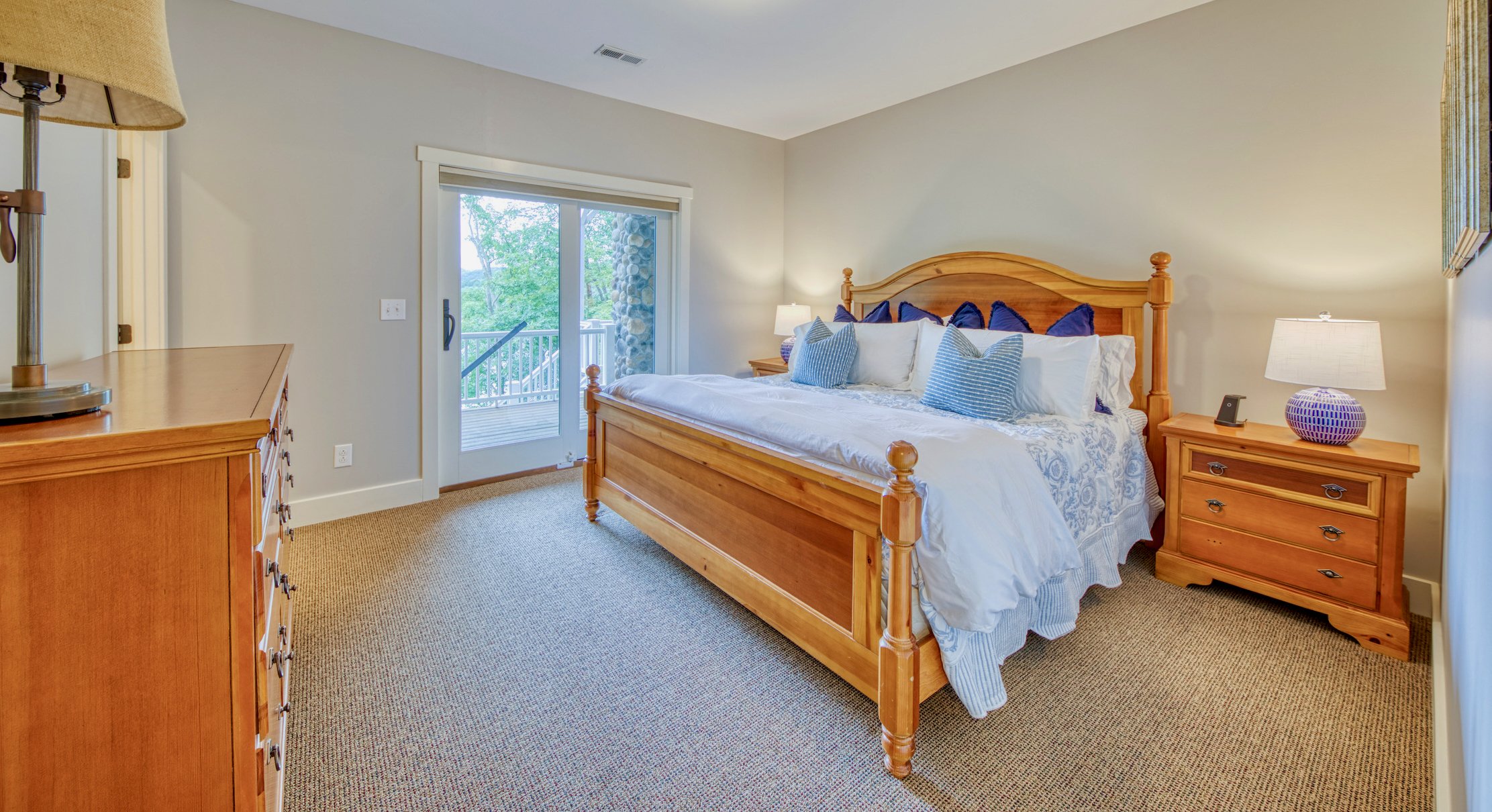 Lower-level king bedroom with lake views and deck access
