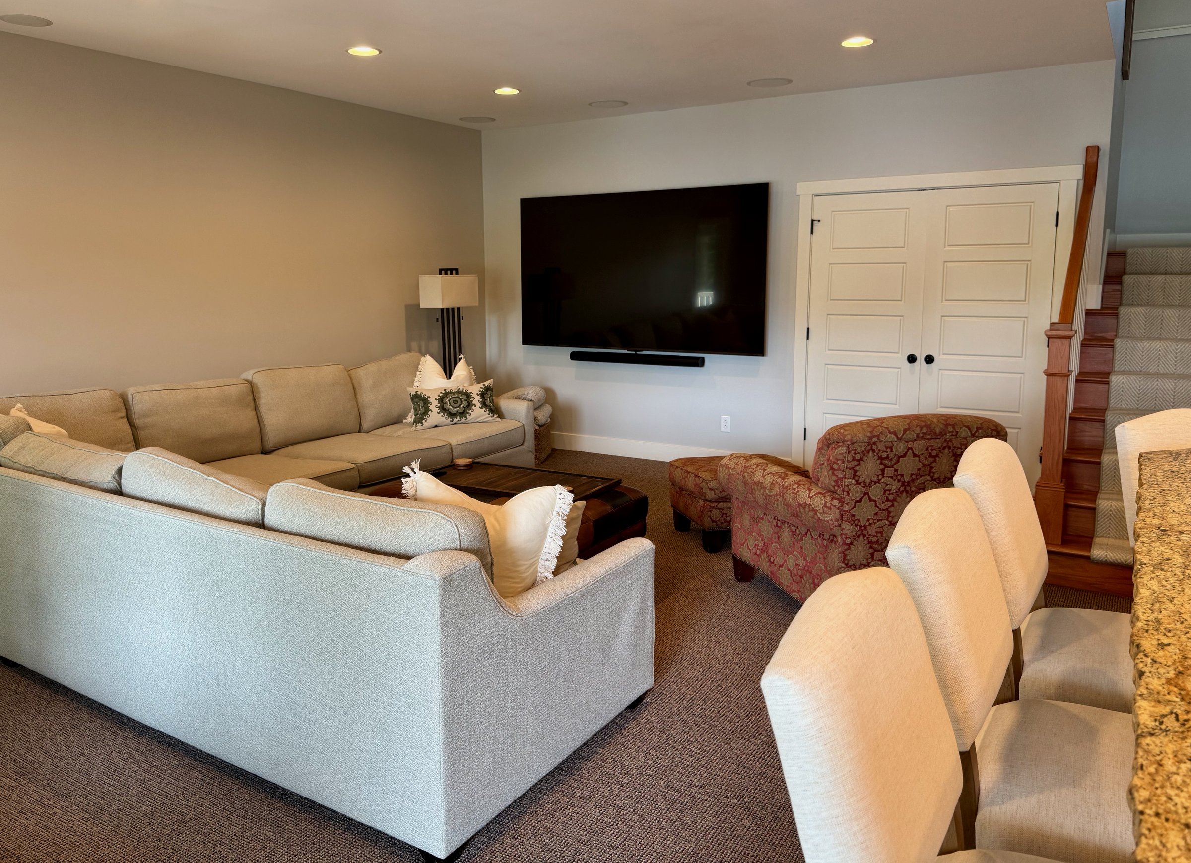 Expansive lower-level media room with a 100-inch TV