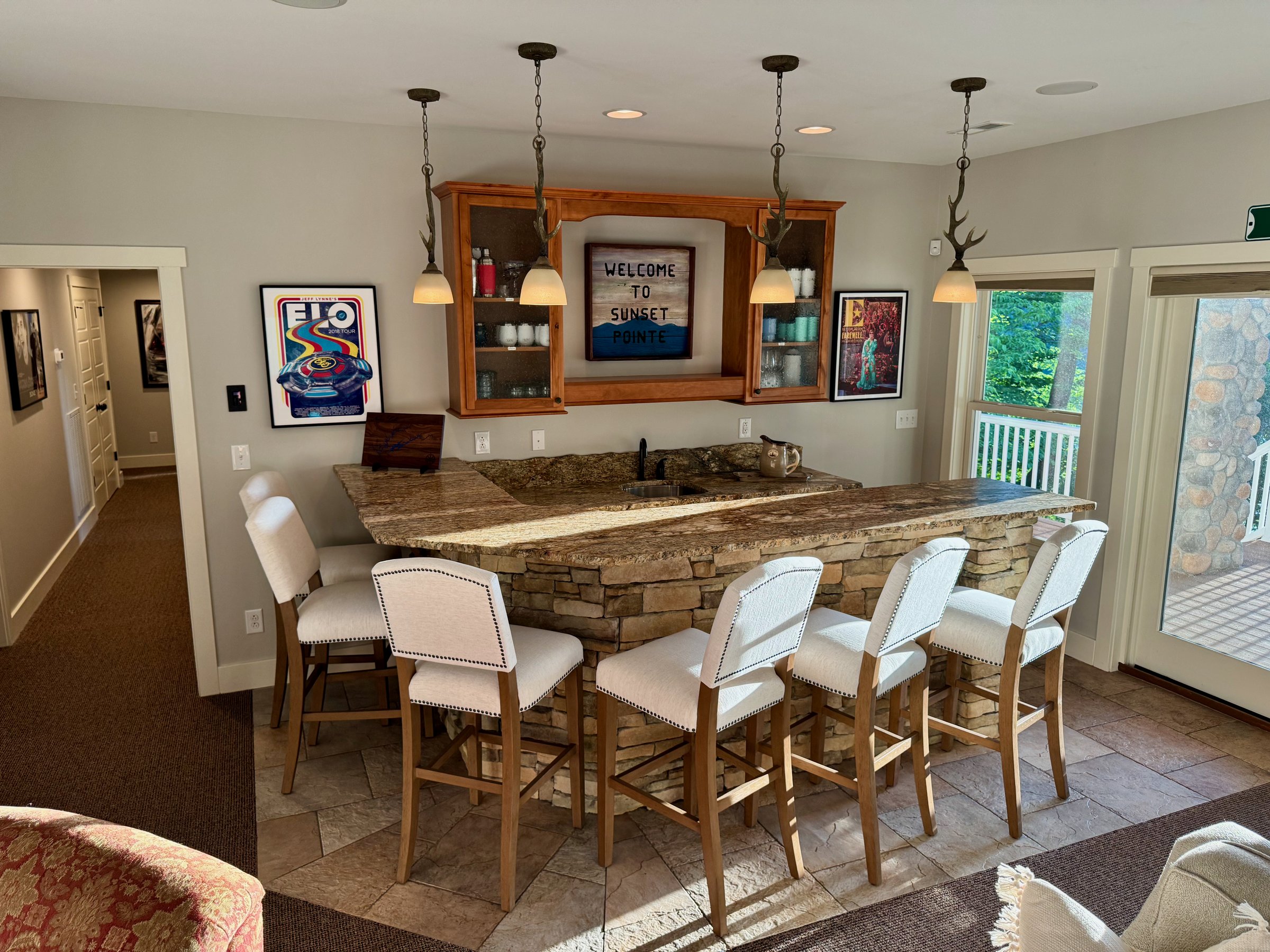 Spacious lower-level living area with a large bar