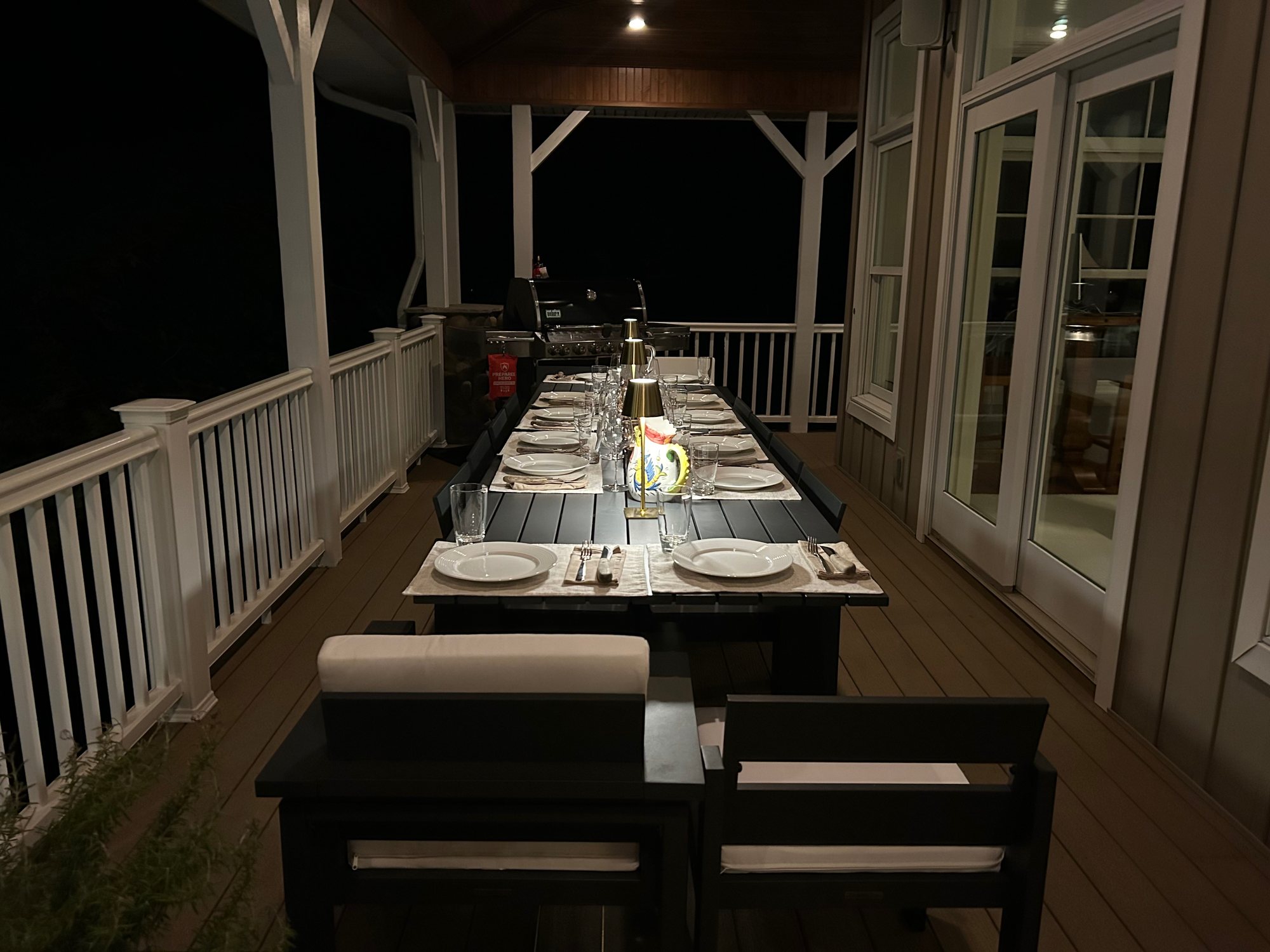 The new outdoor dining table on the covered porch, set for dinner