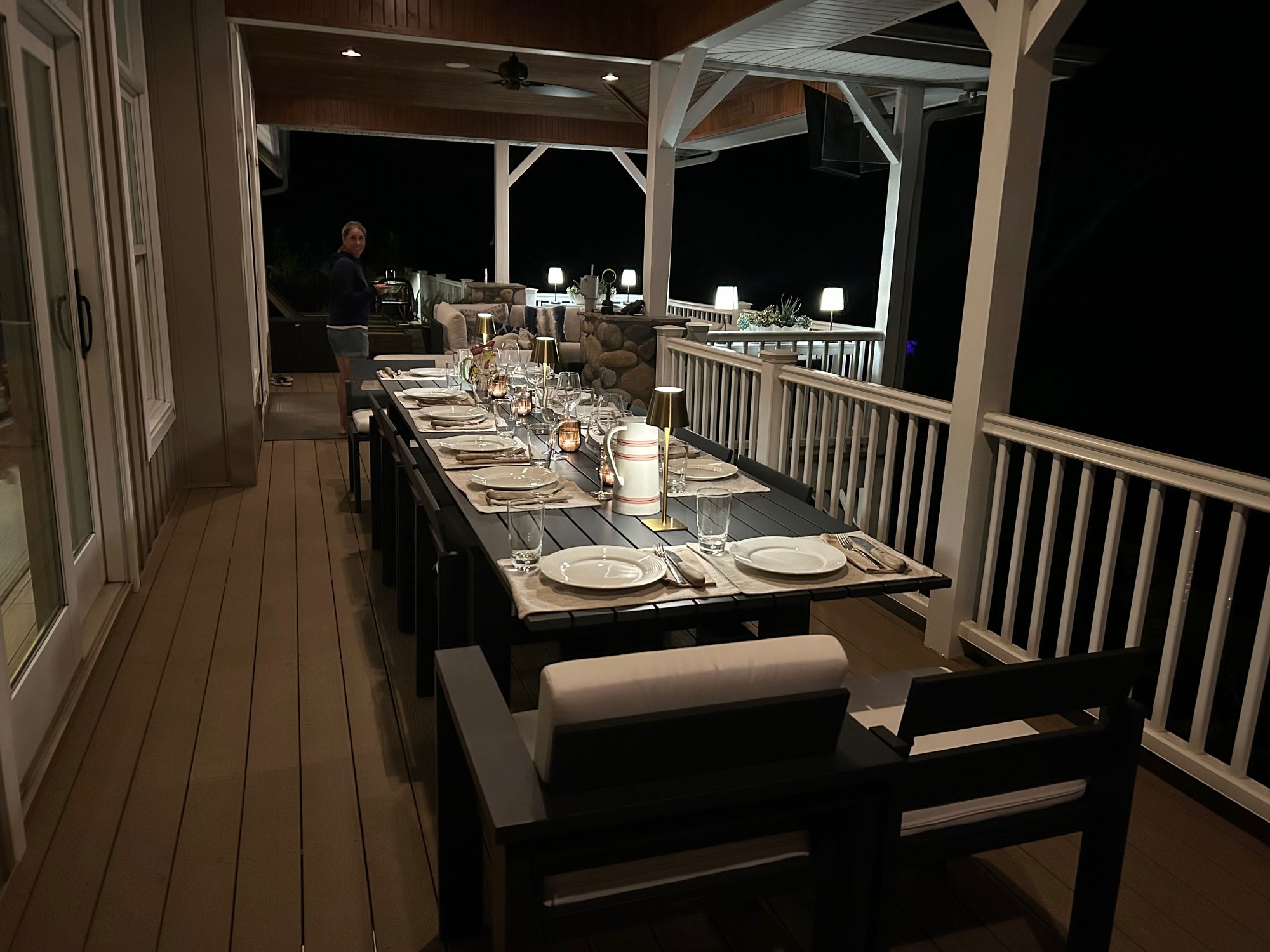 The new outdoor dining table on the covered porch, set for dinner