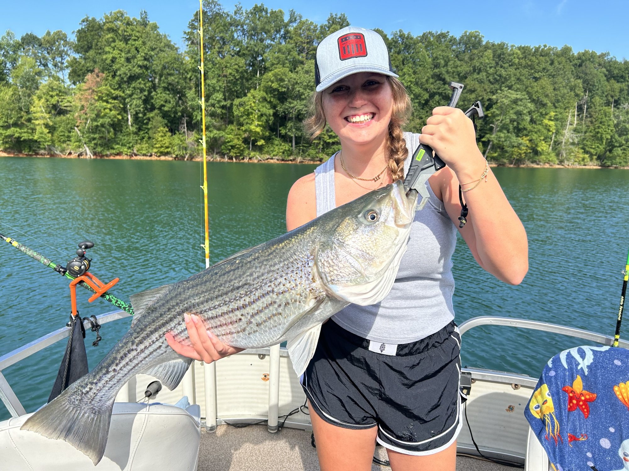 Guest holding a striped bass caught on Norris Lake